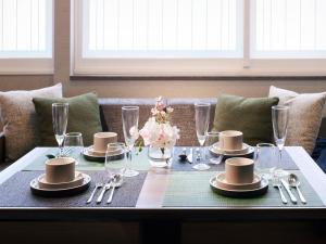 a table with plates and glasses on top of it at Minn Shijo Omiya in Kyoto