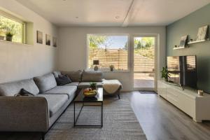 a living room with a couch and a table at Landvetter Apartment in Landvetter