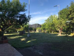 a park with green grass and trees and a street light at Villa Campestre SAN JOSÉ in Guamo