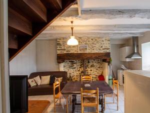a kitchen and living room with a table and chairs at Maison indépendante en pleine nature dans la Vallée de l'Auvézère - FR-1-616-140 in Saint-Mesmin