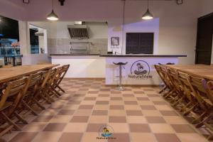 a restaurant with wooden tables and chairs and a counter at Natural View Resorts Melgar in Melgar