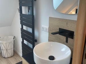 a bathroom with a white sink and a mirror at Gîte spacieux et confortable proche de La Flèche - FR-1-410-471 in Villaines-sous-Malicorne +19 photos
