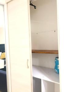 a white cabinet with a wooden shelf in a room at Best location in Medellin close to unicentro in Medellín