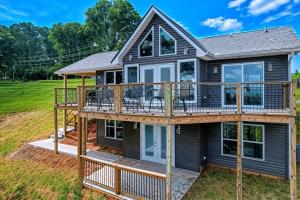 a house with a wrap around deck at Broadview, River, Golf Course, Games, free Attraction Tickets, WIFI!!! in Kodak