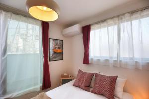 um quarto com cortinas vermelhas e uma cama com almofadas em SCD155 Spacious Villa in Ikebukuro Suburbs Direct Access to Tokyo's Core Commercial Districts em Tóquio