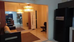 a living room with a couch and a chair and a chandelier at Casa espaçosa, toda climatizada, com piscina, área gourmet, playground in Cuiabá