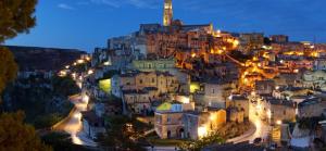 a view of a city at night at MAGNIFICAT luxury rooms in Matera