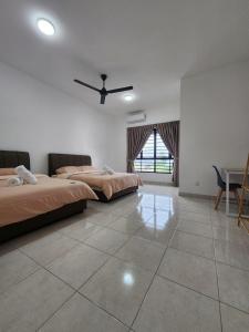 a bedroom with two beds and a ceiling fan at 31 RIMBUN KIARA KEPAYANG SEREMBAn in Seremban