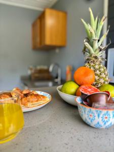 two plates of food on a counter with fruit at Kataléa - Plage à moins de 2 minutes à pieds in Grand-Bourg +10 photos