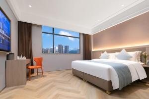 Voodi või voodid majutusasutuse Ramada by Wyndham Wuhan Wangjiawan toas