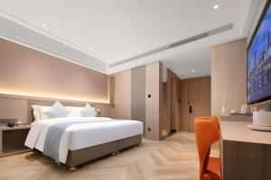 Voodi või voodid majutusasutuse Ramada by Wyndham Wuhan Wangjiawan toas