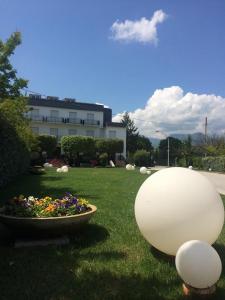 a garden with a large white ball in the grass at Hotel Di Rocco in Loreto Aprutino