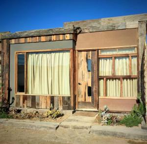 an old building with wooden doors and windows at Espacio modular privado in Coquimbo