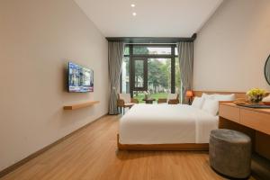 a hotel room with a bed and a window at PCA HOTEL 1 - Vinhomes Ocean Park in Gia Lâm Pho +16 photos