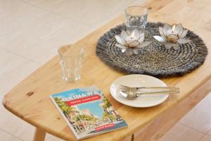 a table with a magazine and a book on it at Maeda Vacation Style in Onna