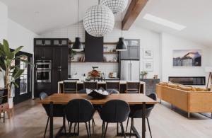 a kitchen and dining room with a table and chairs at Midtown Oasis in Fort Collins