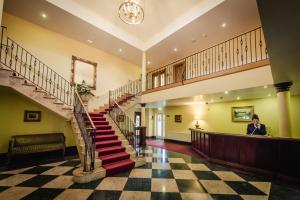 a woman standing in the lobby of a building at Roganstown Hotel & Country Club in Swords