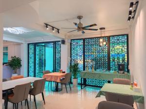 a restaurant with tables and chairs and a stained glass window at Apollo Vientiane Hotel in Vientiane