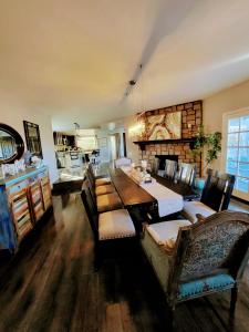 a dining room with a table and chairs and a fireplace at Enchanting Chateau By The Beach - STR15-0330 in Dana Point