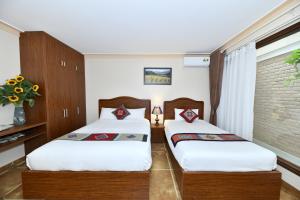 Postel nebo postele na pokoji v ubytování Sapa Symphony Hotel