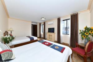 Postel nebo postele na pokoji v ubytování Sapa Symphony Hotel