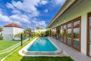 a swimming pool in the backyard of a house at Villa Maria-2BR Private Villa in Canggu in Kerobokan