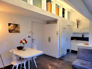 a living room with a table and a kitchen at Cosy flat, central location in Brussels +14 photos