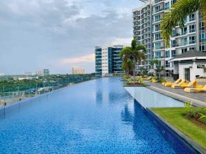 a large swimming pool on the side of a building at Mactan Newtown Beach Condo in Lapu Lapu City