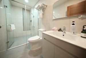 a bathroom with a toilet and a sink and a shower at 芙若蕥居 in Qingshui