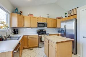a kitchen with wooden cabinets and a stainless steel refrigerator at Family home 2 Master Suites with King beds fast Wifi workspace in Foxfield