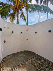 a white wall with palm trees in the background at Julita Boutique Villas in Burgos