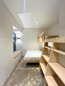 a room with a bed and shelves and a window at Julita Boutique Villas in Burgos