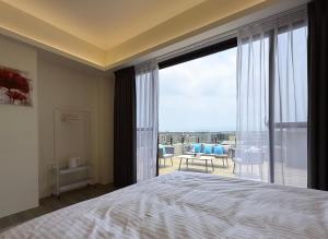 a bedroom with a bed and a large window at 芙若蕥居 in Qingshui