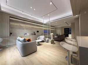 a living room with couches and chairs and tables at 芙若蕥居 in Qingshui
