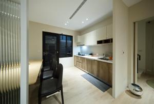 a kitchen with black chairs and a dining room at 芙若蕥居 in Qingshui