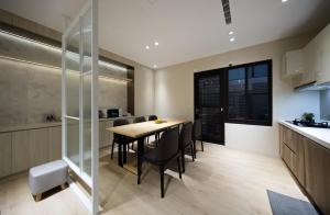 a kitchen and dining room with a table and chairs at 芙若蕥居 in Qingshui