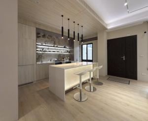a kitchen with a white counter and a bar with stools at 芙若蕥居 in Qingshui