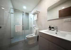 a bathroom with a toilet and a sink and a shower at 芙若蕥居 in Qingshui