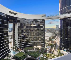 an aerial view of a large building with a city at Queen's Wharf Residences Official in Brisbane