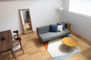 a living room with a couch and a table at LIRI 葵 3min to JR弁天町 Direct to USJ & Umeda & EXPO in Osaka