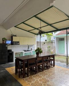a kitchen with a table and some chairs and a kitchen with at vintage room 1 in colonial house in Kamparganya