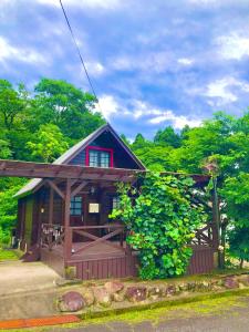 a small house with a porch and a fence at Makino MegRia in Takashima