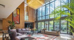 a large living room filled with furniture and large windows at Sichuan Tennis International Hotel Main Building in Chengdu