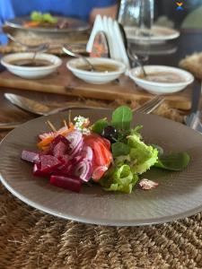 a plate of food with vegetables on a table at Mara Sidain lodge in Sekenani