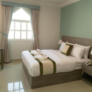 a bedroom with a large bed with towels on it at Sovereign Hotel - Marriage Certificate Required in Doha