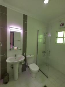 a bathroom with a toilet and a sink and a shower at Sovereign Hotel - Marriage Certificate Required in Doha +47 photos