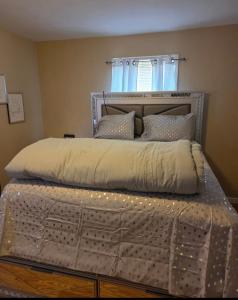 a bedroom with a bed with a metal frame at Comfortable & Relaxing Charming 3BR unit in Chicago
