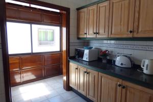 a kitchen with wooden cabinets and a window at Casa Bonica in Playa Blanca