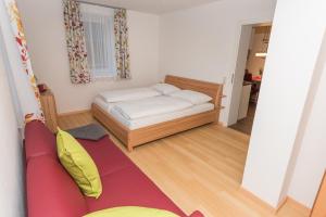 a small room with a bed and a couch at Apartment Angerer Bad Aussee in Bad Aussee
