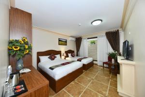 Postel nebo postele na pokoji v ubytování Sapa Symphony Hotel + 25 fotografií